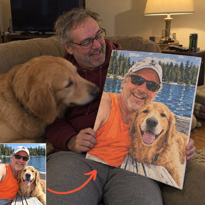 Man with his golden retriever holding the custom paint by numbers canvas of their lake photo, with the original photo